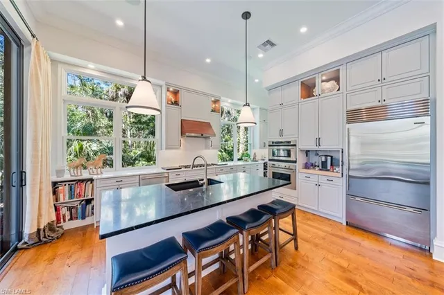 a kitchen with a table chairs stove and cabinets