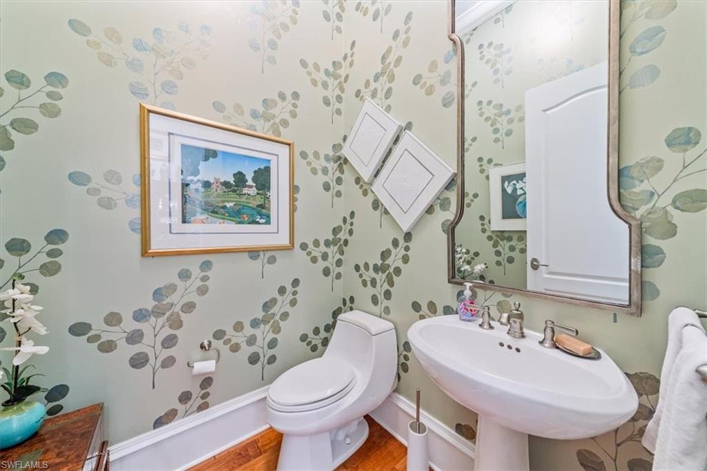 18051 Lagos Way Naples, FL 34110 - Photo 16 of 26 a bathroom with a toilet sink and mirror