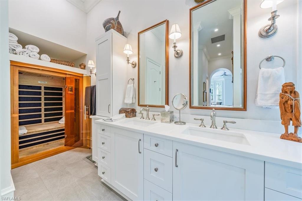 18051 Lagos Way Naples, FL 34110 - Photo 18 of 26 a bathroom with a double vanity sink mirror and double