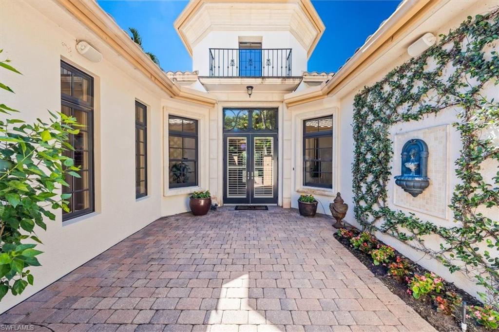 18051 Lagos Way Naples, FL 34110 - Photo 2 of 26 a living room with furniture and a large window