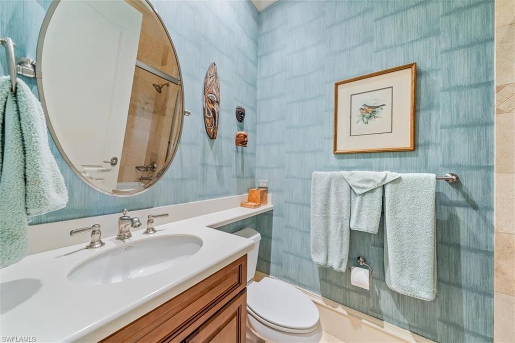 18051 Lagos Way Naples, FL 34110 - Photo 21 of 26 a bathroom with a sink a toilet and shower