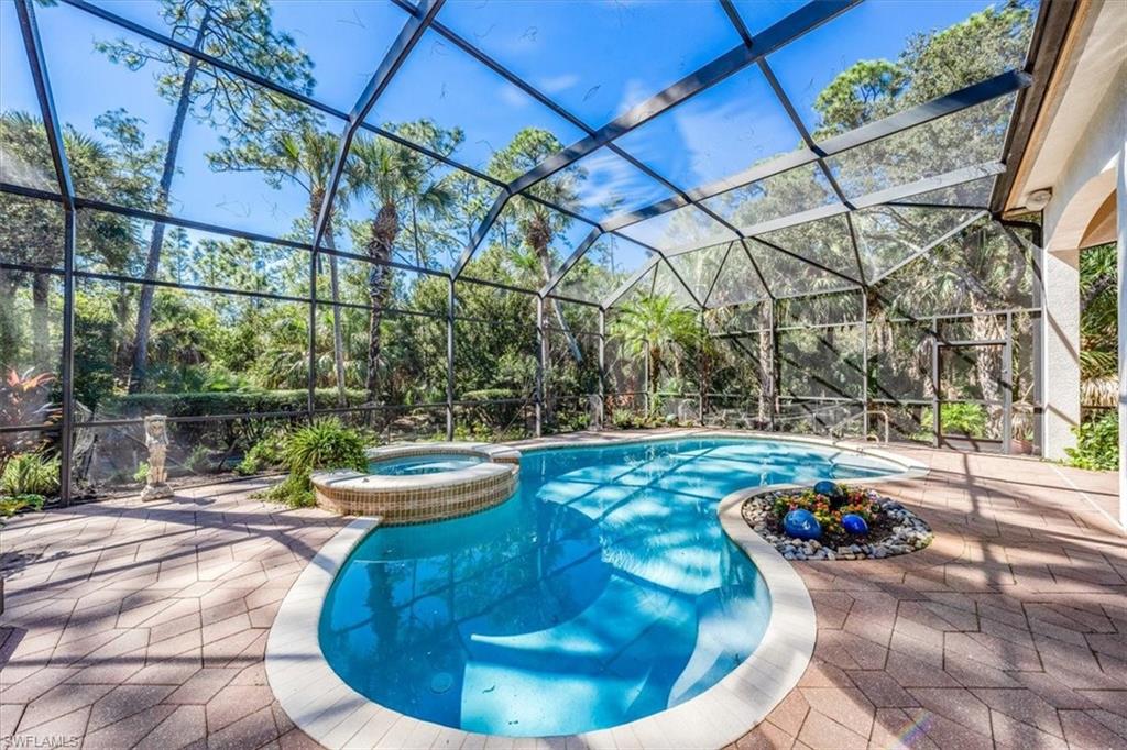 18051 Lagos Way Naples, FL 34110 - Photo 25 of 26 a view of a swimming pool with a patio