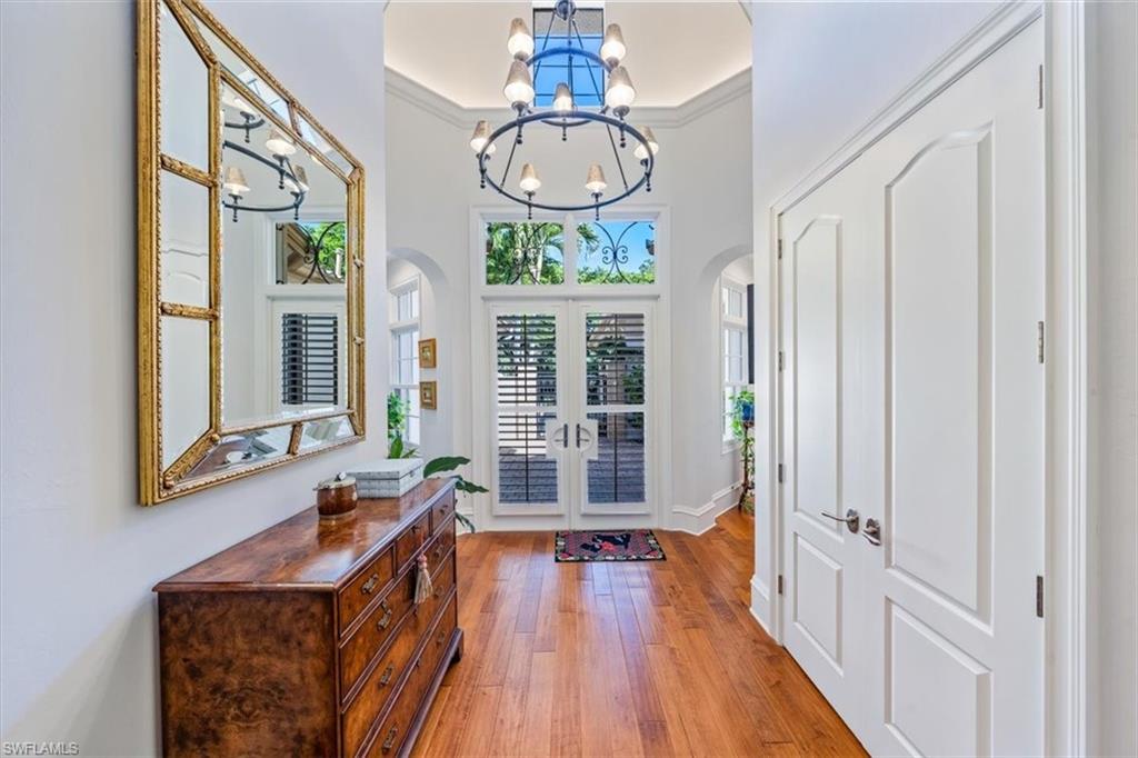 18051 Lagos Way Naples, FL 34110 - Photo 3 of 26 a very nice looking room with wooden floor and windows