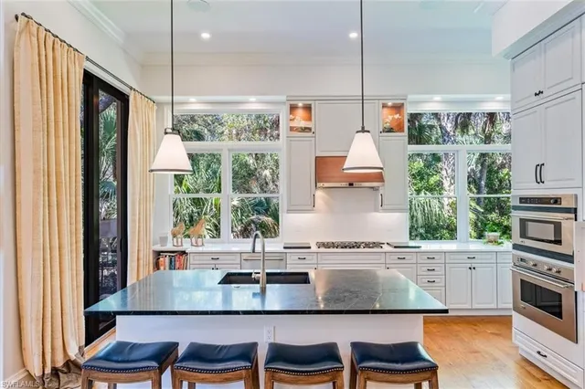 a kitchen with a table chairs stove and cabinets