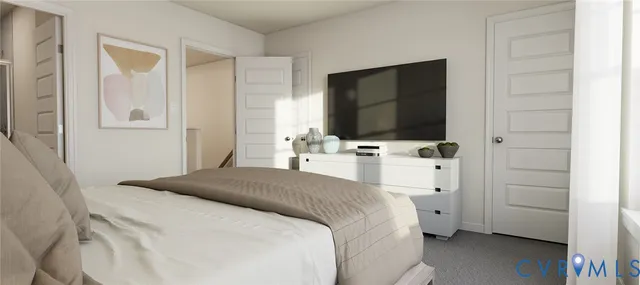 a bedroom with a bed table and flat screen tv