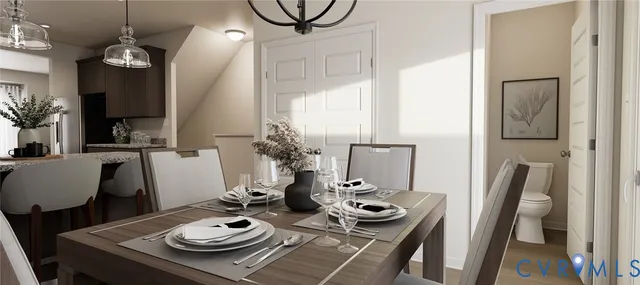 a view of a dining room with furniture a rug and wooden floor