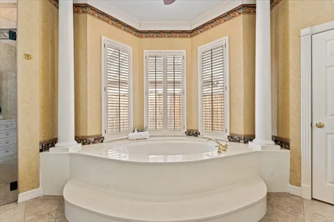 a bath tub sitting in a bathroom next to a window