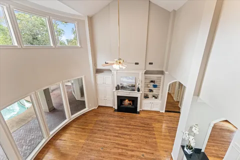 a view of kitchen with stainless steel appliances wooden floor and window