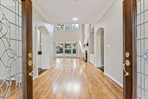 a view of a hallway with wooden floor and staircase