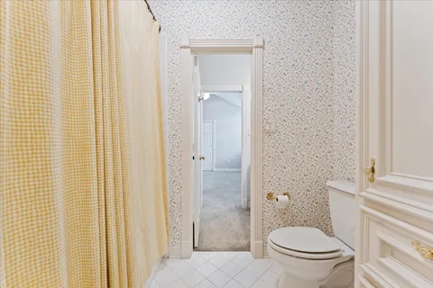 a bathroom with a granite countertop toilet and a shower