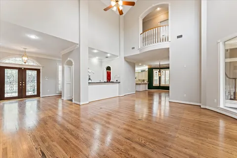 a view of an empty room and window with wooden floor