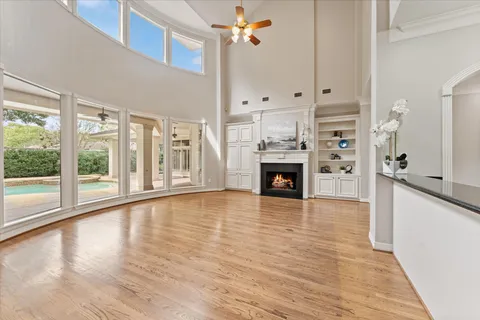 a view of a kitchen with wooden floor a fireplace and windows