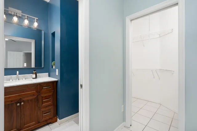 a bathroom with a double vanity sink and mirror