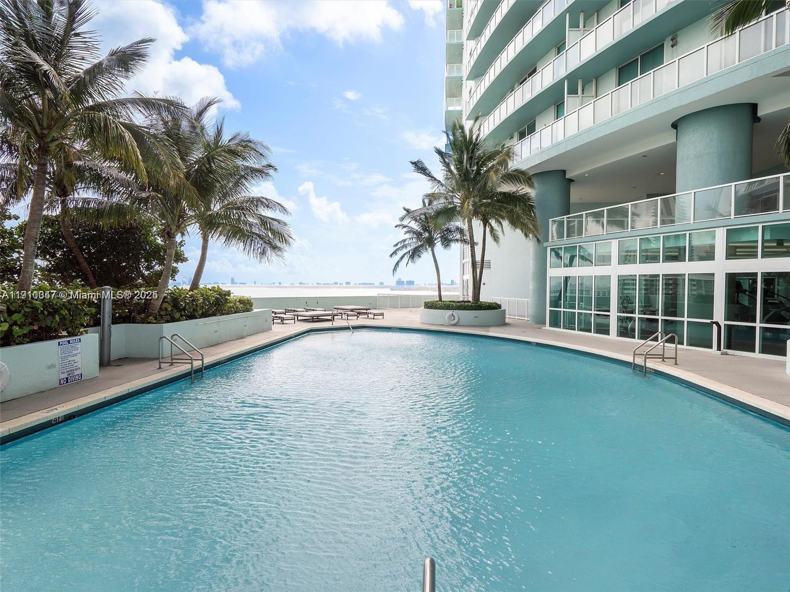 1900 North Bayshore Drive, Unit 1614 Miami, FL 33132 - Photo 12 of 15 a view of a swimming pool with a yard