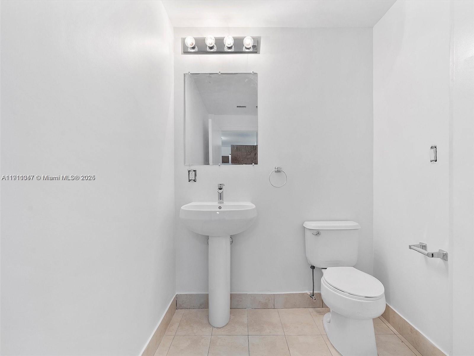 1900 North Bayshore Drive, Unit 1614 Miami, FL 33132 - Photo 10 of 15 a bathroom with a sink toilet and a mirror