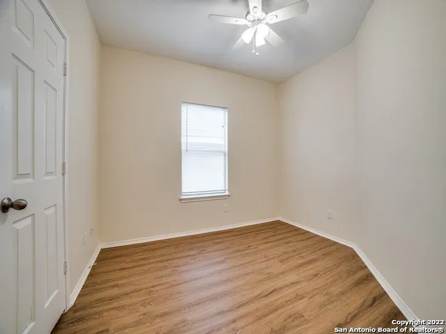 wooden floor in an empty room with a window