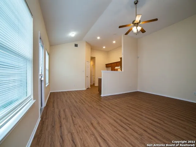 a view of empty room with wooden floor
