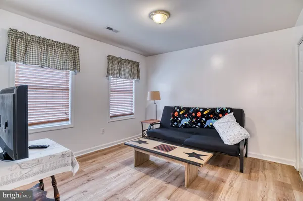 a living room with furniture and a ceiling fan