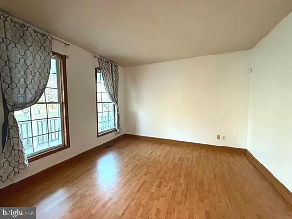 a living room with furniture a flat screen tv and a large window