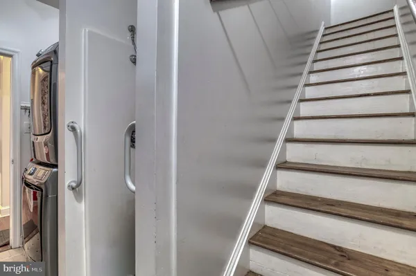 a view of a house with backyard water fountain and sitting area