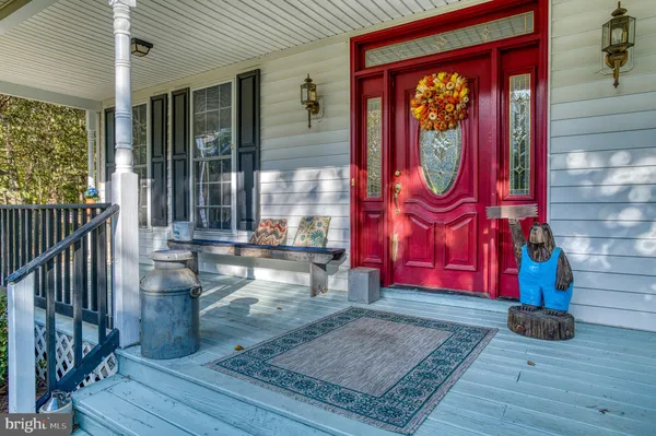a patio with wooden floor a yard a table and chairs