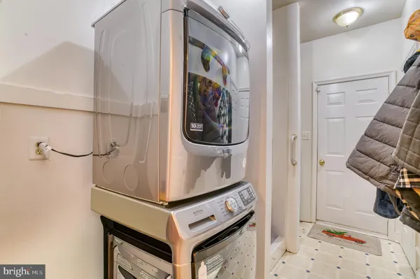 a kitchen with stainless steel appliances granite countertop a dining table chairs and granite floor