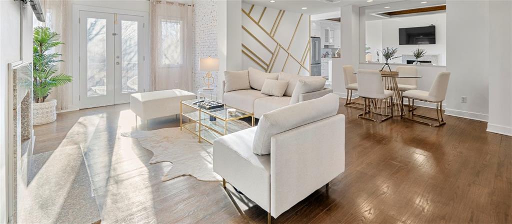 a living room with furniture and floor to ceiling windows