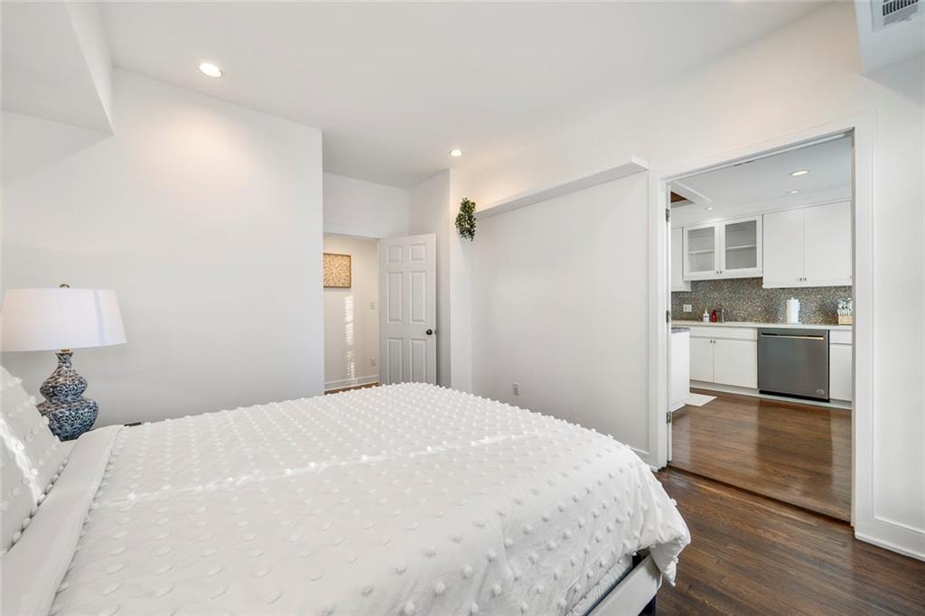 2840 Peachtree Road Northwest, Unit 502 Atlanta, GA 30305 - Photo 11 of 27 a spacious bedroom with a bed and a view of kitchen
