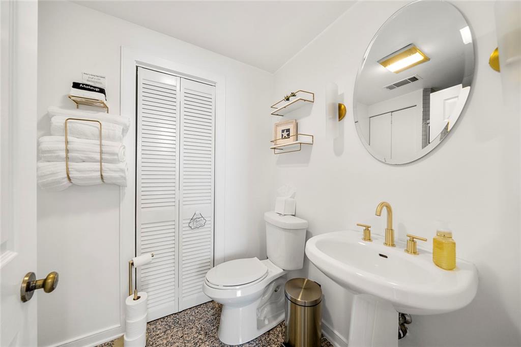 2840 Peachtree Road Northwest, Unit 502 Atlanta, GA 30305 - Photo 13 of 27 a bathroom with a sink toilet and mirror