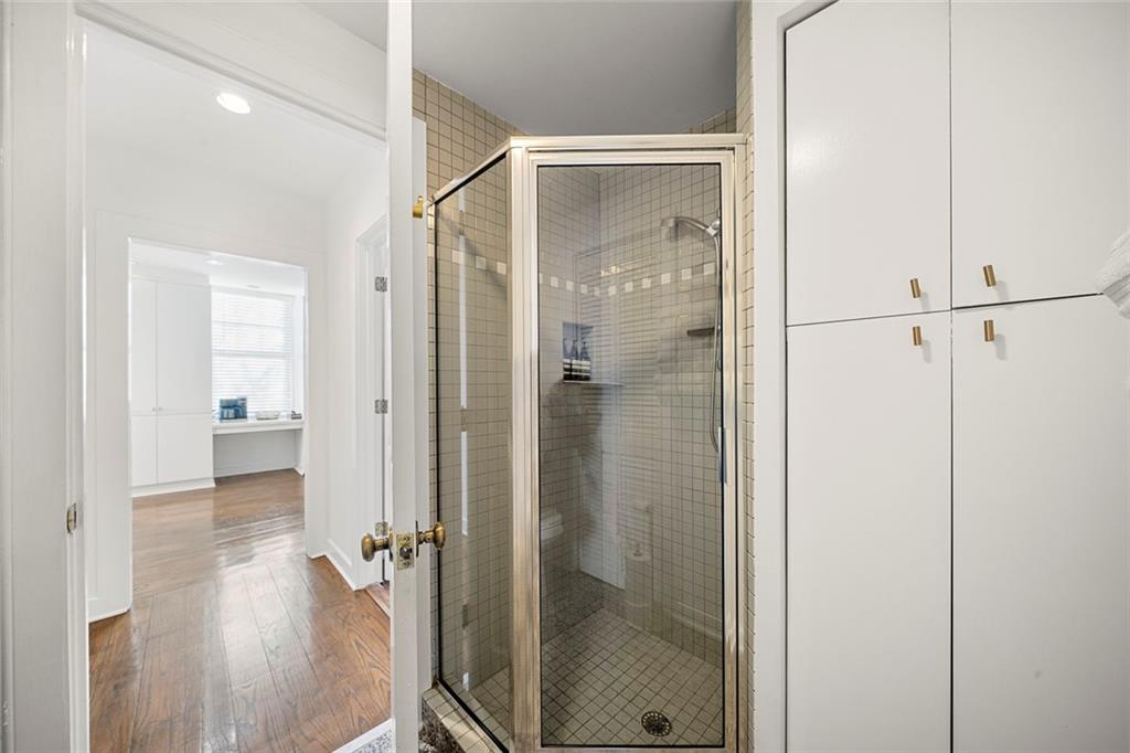 2840 Peachtree Road Northwest, Unit 502 Atlanta, GA 30305 - Photo 14 of 27 a bathroom with a glass shower door and a toilet