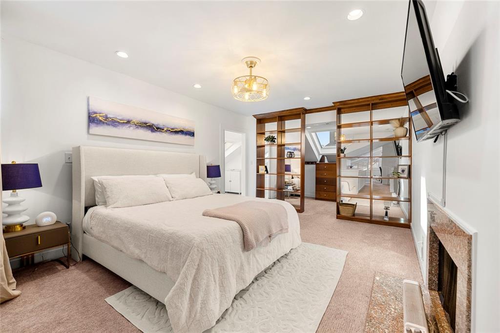 2840 Peachtree Road Northwest, Unit 502 Atlanta, GA 30305 - Photo 16 of 27 a bedroom with a bed couch and a window