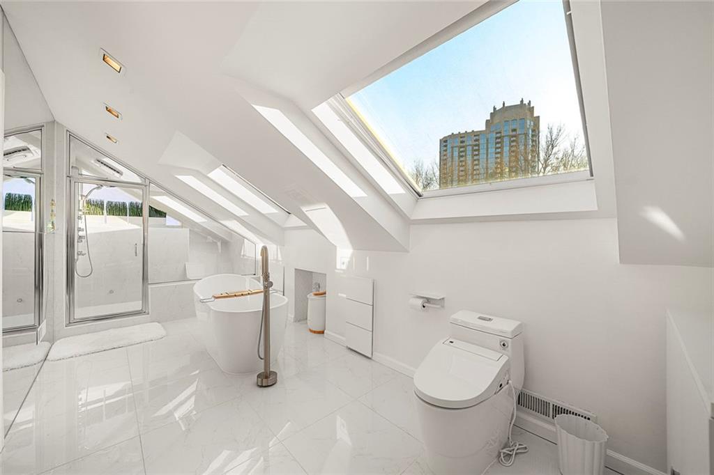 2840 Peachtree Road Northwest, Unit 502 Atlanta, GA 30305 - Photo 21 of 27 a white toilet sitting next to a bathroom sink