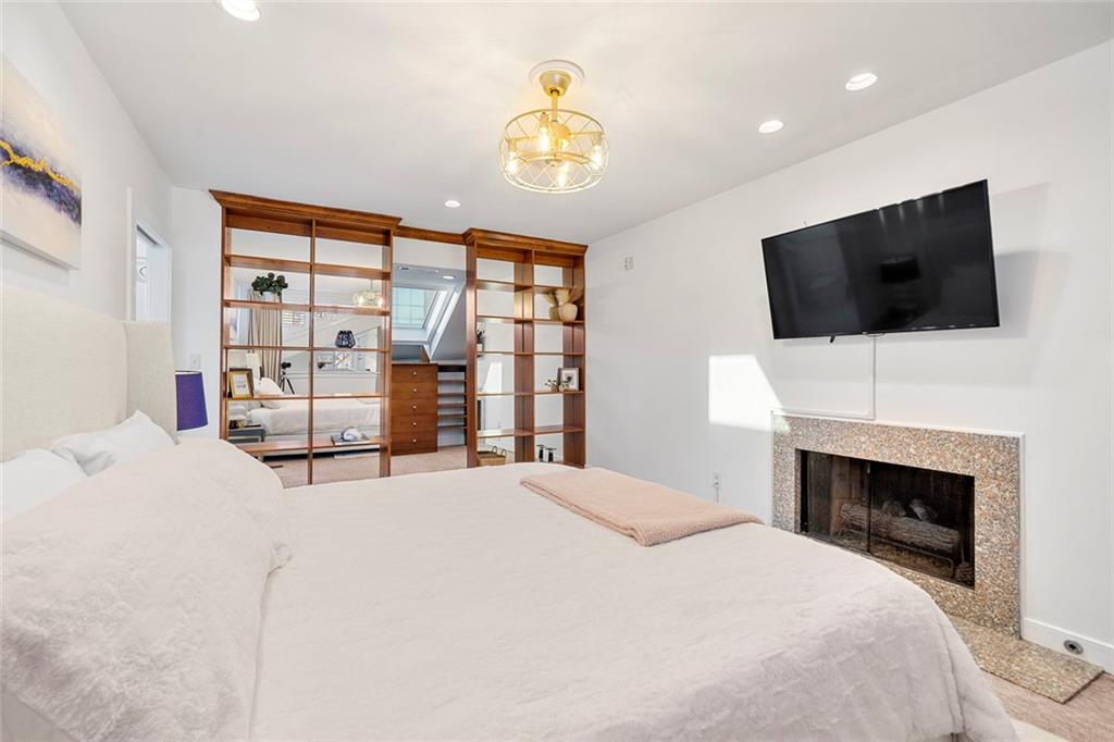 2840 Peachtree Road Northwest, Unit 502 Atlanta, GA 30305 - Photo 25 of 27 a bedroom with a large bed and a flat screen tv