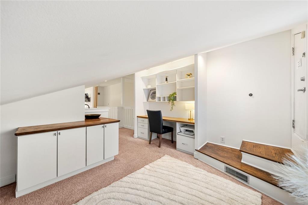 2840 Peachtree Road Northwest, Unit 502 Atlanta, GA 30305 - Photo 27 of 27 a room with a bed and a chair in it