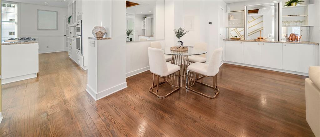 2840 Peachtree Road Northwest, Unit 502 Atlanta, GA 30305 - Photo 5 of 27 a view of a room with wooden floor and furniture