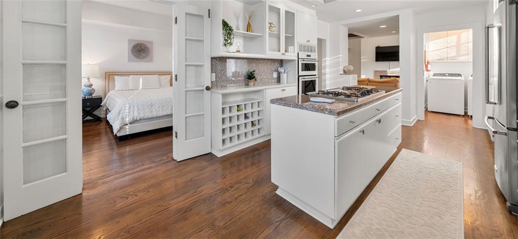 2840 Peachtree Road Northwest, Unit 502 Atlanta, GA 30305 - Photo 9 of 27 a kitchen with stainless steel appliances a white stove top oven and a refrigerator