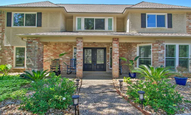 a front view of a house with garden