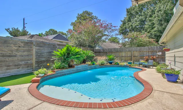a view of a swimming pool with a patio
