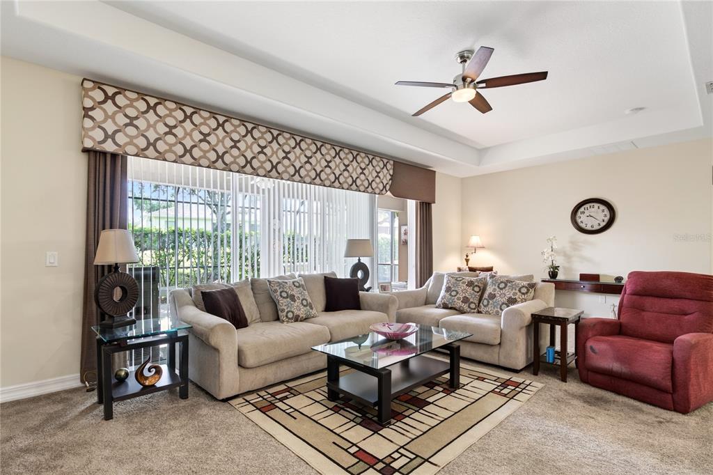 3651 Limestone Street Clermont, FL 34711 - Photo 12 of 41 a living room with furniture a ceiling fan and a large window