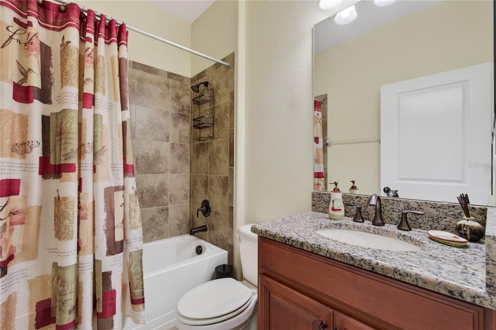 3651 Limestone Street Clermont, FL 34711 - Photo 25 of 41 a bathroom with a granite countertop sink a toilet and shower
