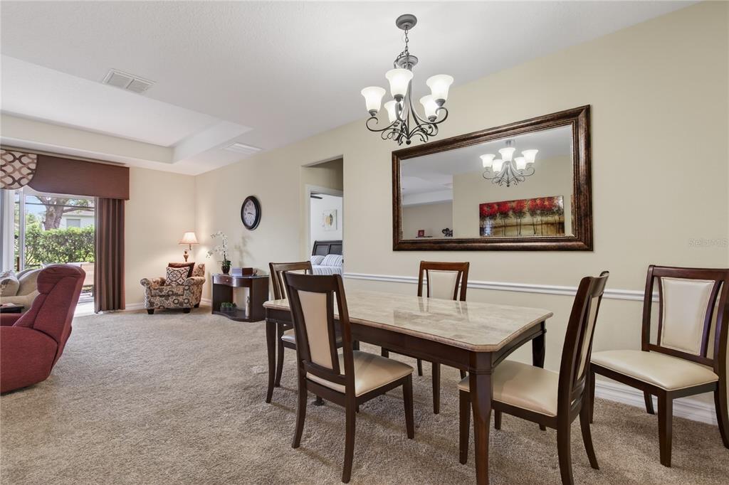 3651 Limestone Street Clermont, FL 34711 - Photo 9 of 41 a view of a dining room with furniture and a chandelier
