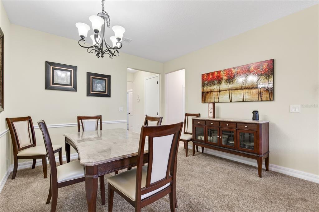 3651 Limestone Street Clermont, FL 34711 - Photo 10 of 41 a view of a dining room with furniture and chandelier