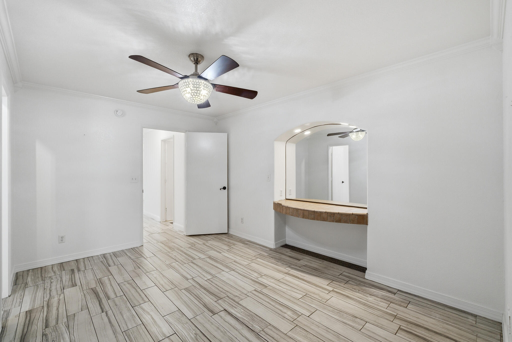 618 Birdsong Court Exeter, CA 93221 - Photo 32 of 62 a view of an empty room with wooden floor and a ceiling fan
