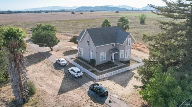 an aerial view of a house with a lake view