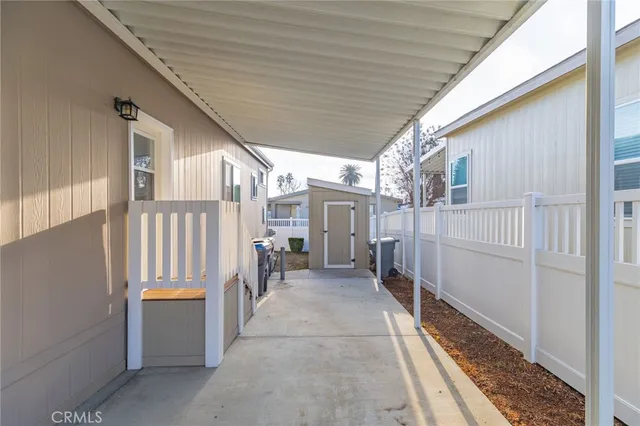 a view of a porch with wooden floor and fence