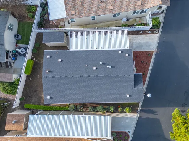 an aerial view of a house with garden space and lake view