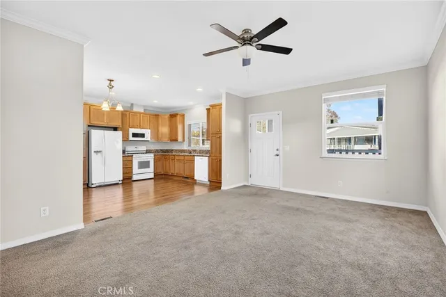 an empty room with a kitchen and windows