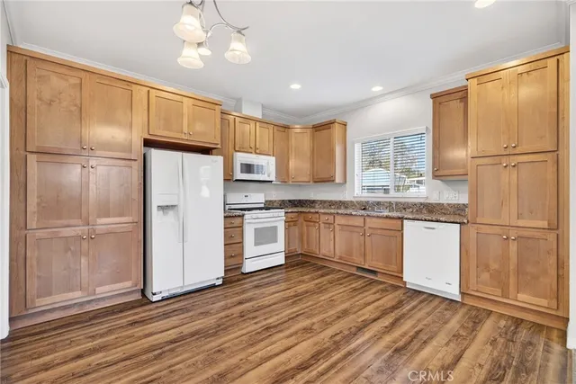 a kitchen with a refrigerator a sink and cabinets