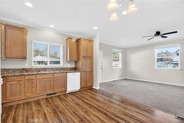 a large kitchen with granite countertop a stove a sink and a refrigerator