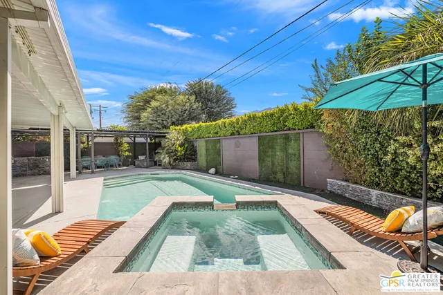 a view of a backyard with sitting area